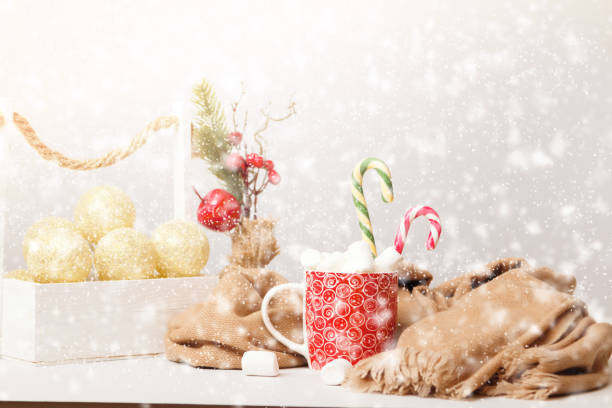 istock Happy cozy Christmas. A mug with marshmallows and a warm blanket with a defocused snowfall. 1441832884