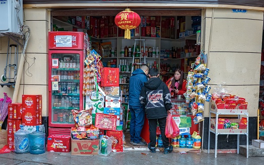chongqing, China – January 29, 2022: People shopping at the entrance of the Chinese grocery store in Chongqing, China
