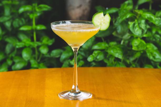 istock Orange-colored cocktail with cucumber dressing on a wooden table 1441833410