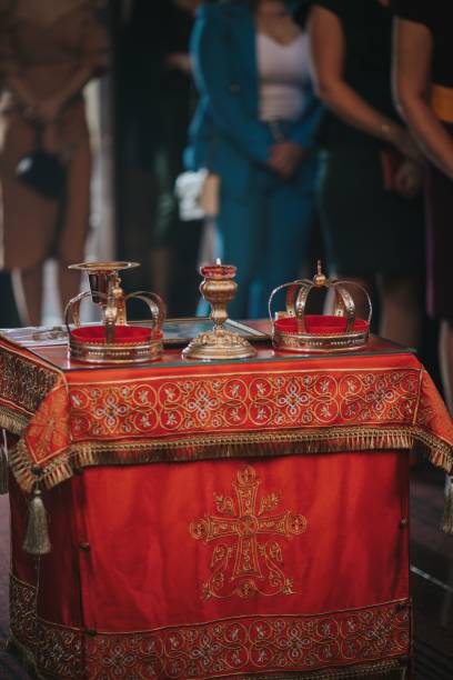 istock Closeup of bridge and groom crowns on liturgical table 1441833802