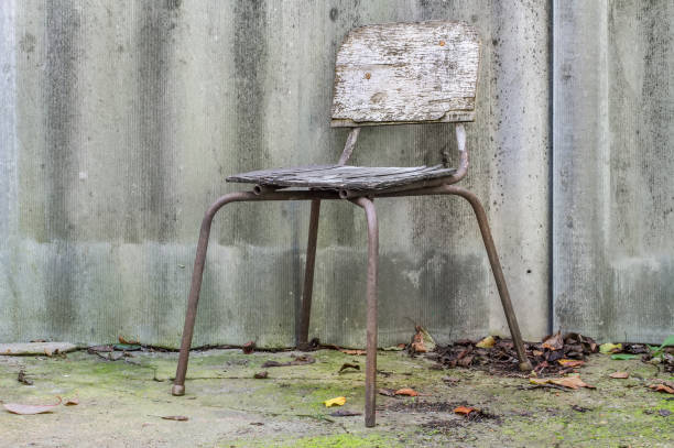 istock Old damaged stool against a slate background. 1441834167