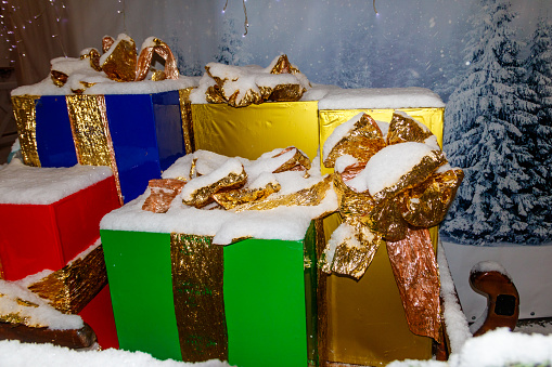 Big Christmas gift boxes covered with white snow
