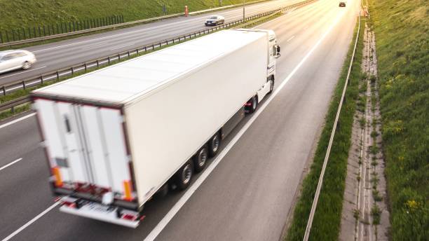 istock Big freight trucks on a highway with motion blur effect 1441834769