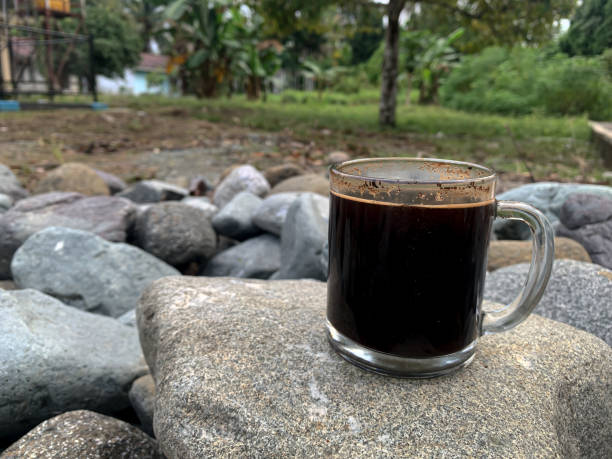 istock a cup of black coffee on a rock on a rock background 1441835905