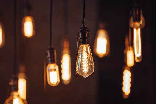 Bright retro lamps hanging on the ceiling of a modern house or cafe