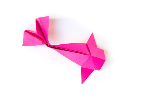 Pink paper fish origami isolated on a blank white background