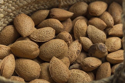nuts, macro of a handful of shelled almonds, horizontal photo