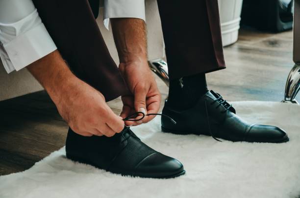 istock Groom getting dressed for the wedding 1441838824