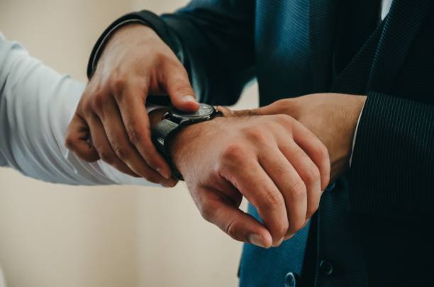 istock Groom getting dressed for the wedding 1441838827
