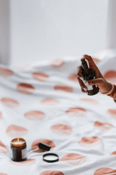 istock African female spraying antibacterial sanitizing spray for clothes and linens before going to bed 1441839526