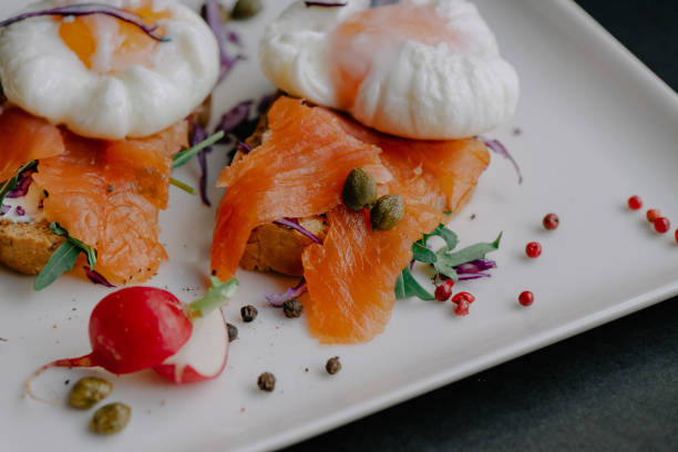 istock Poached eggs benedict served on toast with smoked salmon and arugula 1441840552