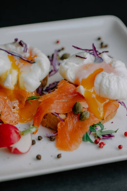istock Poached eggs benedict served on toast with smoked salmon and arugula 1441840560