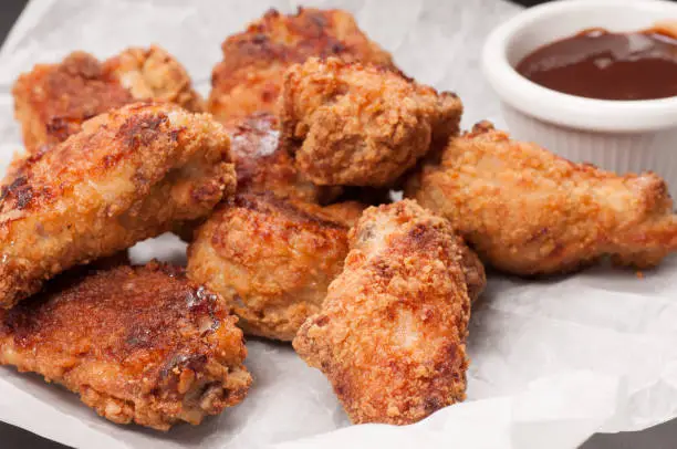 take away breaded chicken wings with bbq dipping sauce