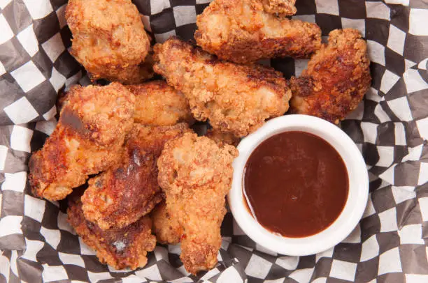 take away breaded chicken wings with bbq dipping sauce