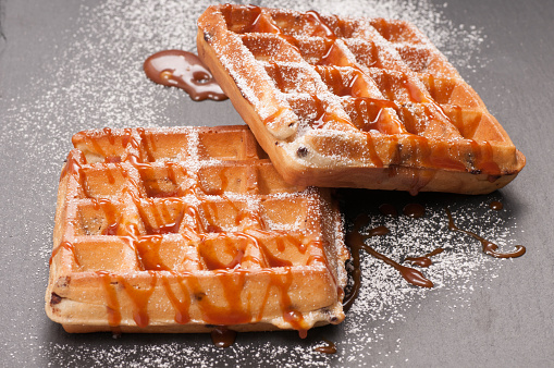 toasted chocolate chip waffles with caramel and powdered sugar
