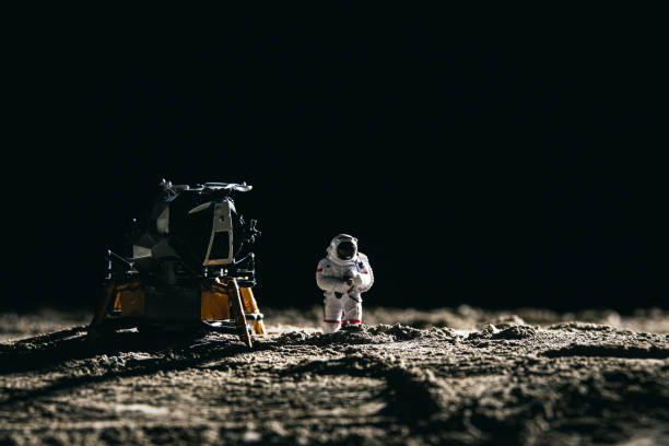 istock Astronaut miniature toy next to a spaceship on the moon 1441841679