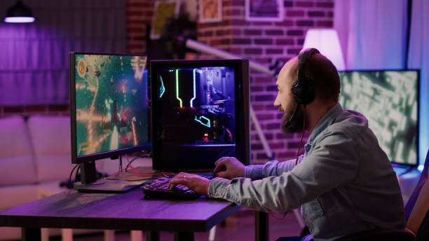 istock Handheld shot of gamer streaming fast paced space shooteron gaming pc setup while explaining gameplay 1441842827