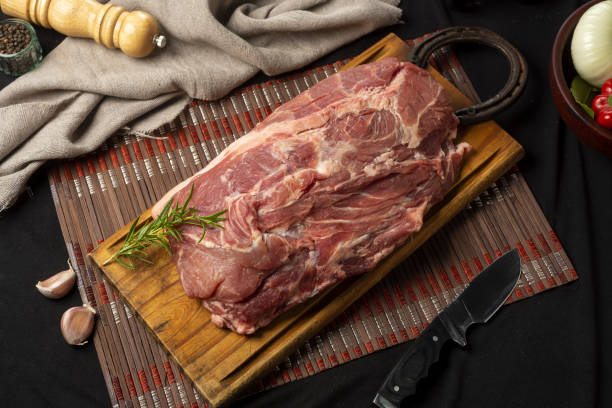 istock High angle show of raw meat on a board with ingredients on the table 1441843187
