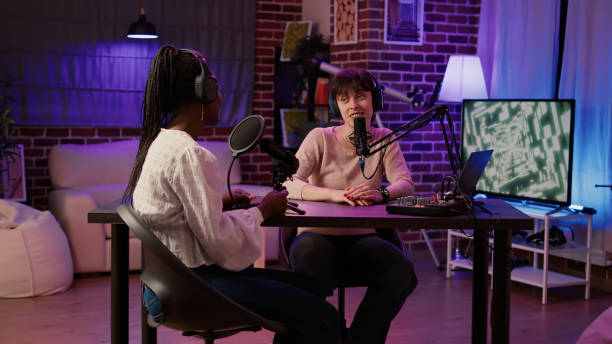 istock Two women recording interview using professional microphone in front of digital camera 1441843354