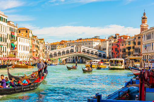 Venice, Italy - September 23, 2019: Panoramic view of the Grand Canal with gondolas and the Rialto Bridge (Ponte di Rialto). Venice, Italy.