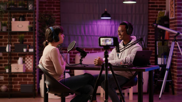 istock African american online radio host recording vlog using digital camera on tripod and intruducing guest to listeners 1441843485