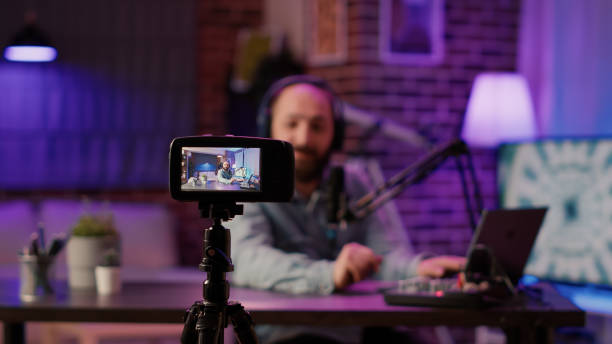 istock Selective focus on digital video camera screen recording influencer caucasian man streaming live talk show using microphone 1441843571