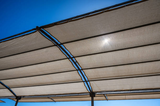 istock Sun shines through fabric roof on beach 1441843996