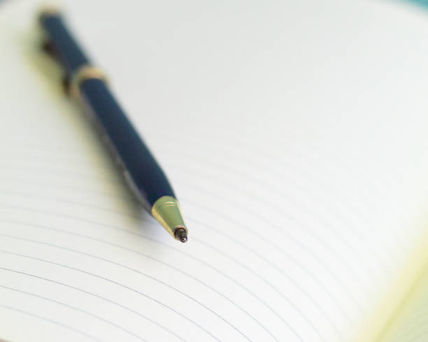 istock Selective focus shot of the blank notepad with a pen 1441844056