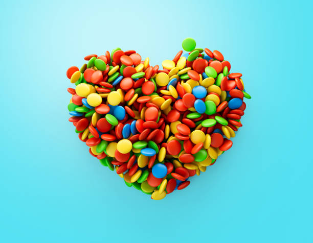 istock Colorful button candies heart shape on Blue background. Top view 3d illustration 1441844666