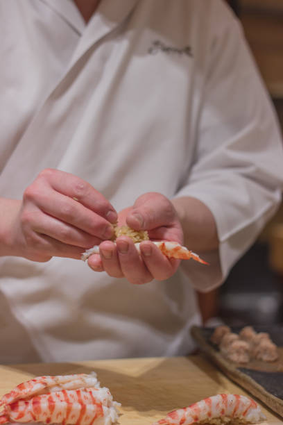 istock Vertical shot of chefs hands making sushi 1441844753