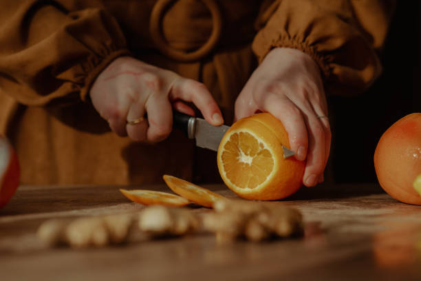 istock Person cutting oranges on a cutting board 1441844931