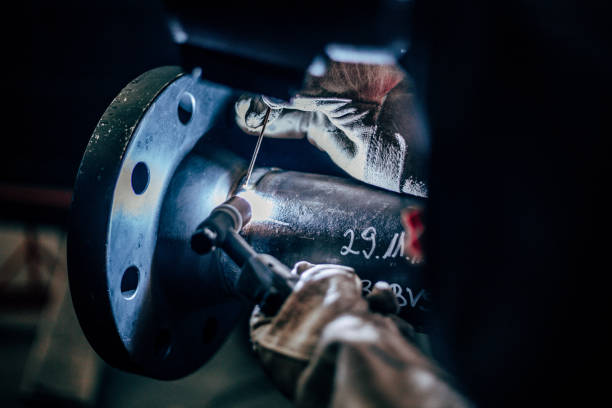 istock Worker welding metal in manufacturing plant 1441845154