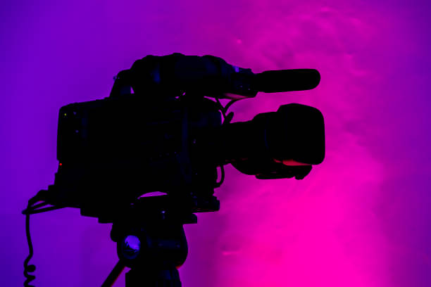 istock Silhouette of a videography camera with a colorful background 1441845330