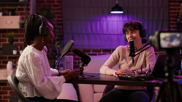 istock Online podcast host recording interview in front of digital camera for vlog using professional microphone 1441846372