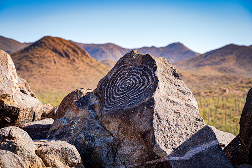 The image shows a beautiful spiral petroglyph on a boulder in Saguaro National Park near Tucson, Arizona