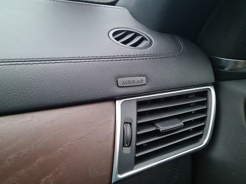 Car dashboard and air conditioning system and airbag panel. Interior detail.