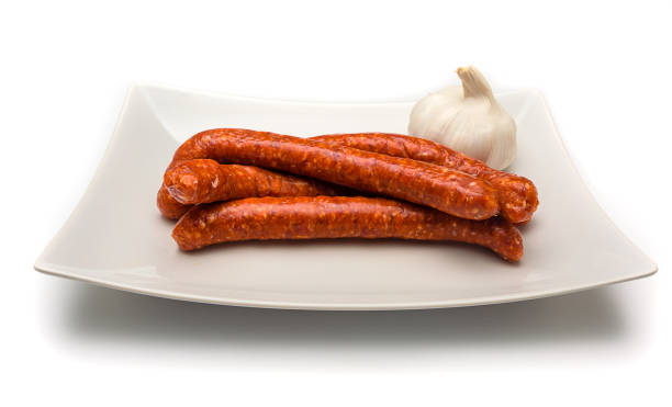 istock Merguez sausages on a dish isolated on white background. 1441847588