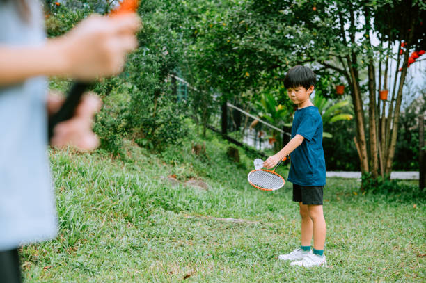 istock Asian Chinese boy learning badminton from grandfather. 1441848345