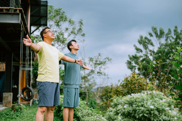 Two Asian Chinese Men are warming up their body and doing Yoga stock photo