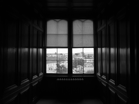 Details of an old wooden window, part of an old Serbian household, during day.