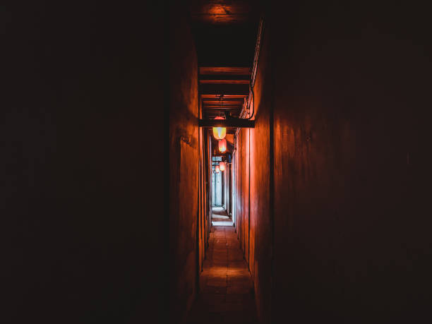 narrow dark corridor illuminated with chinese style lanterns - claustrophobic imagens e fotografias de stock