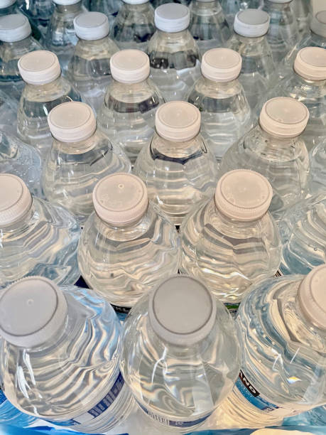 istock Vertical shot of filled water bottles with caps 1441849878
