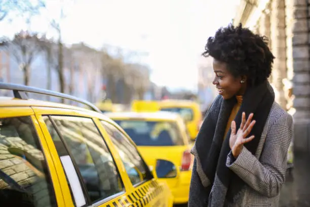 Photo of Young black female with a black scarf saying hi to