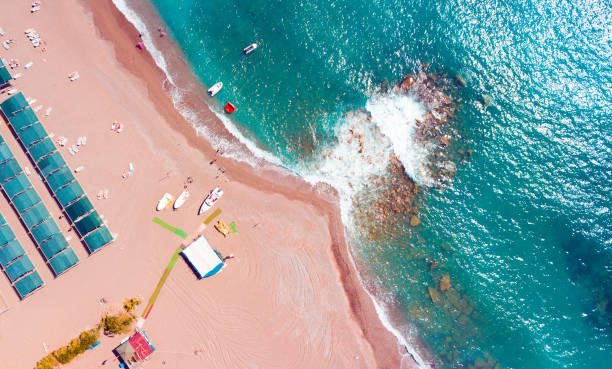 istock Top view of foam waves hitting a sandy seashore 1441850847