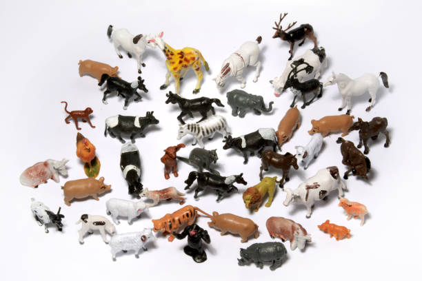istock Closeup top view of small plastic different animal figurines on a reflective white surface 1441851393