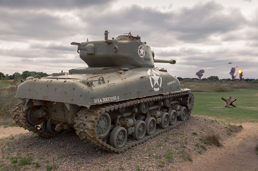 Sainte-Marie-du-Mont, France – August 22, 2018: M4 Sherman tank of the allied troops targeting two German WWII bombers in the Normandy coast on a cloudy day