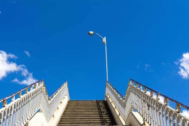 istock Old staircase with rusty railings leading up to a beautiful blue sky 1441852403