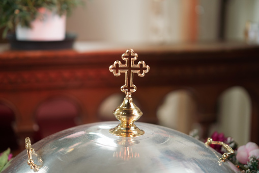 A golden Orthodox cross in the church, a symbol of baptism
