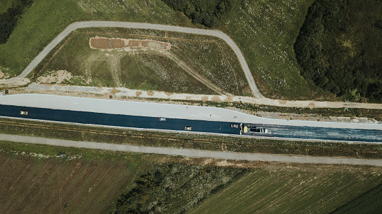 A top view of a road under construction in Brcko district surrounded by fields, Bosnia and Herzegovina