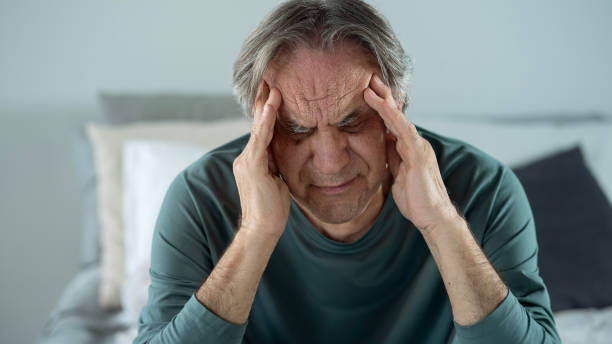 istock Old man holding his head with his hands 1441856880